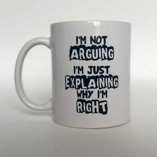 Black text on a white ceramic mug that reads: "I'm Not Arguing I'm Just Explaining Why I'm Right." Funny quote mug for lawyers, debates, or sarcastic coworker gifts.