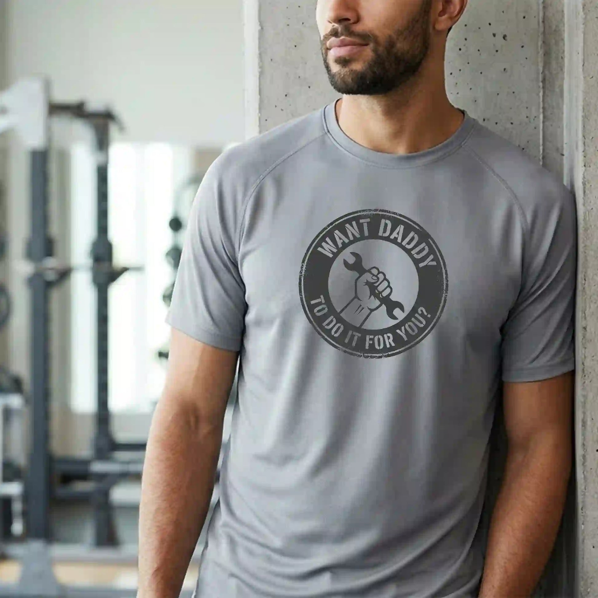 Male model wearing a short-sleeve 'Want Daddy To Do It?' performance tee in Platinum - Humorous workwear for trades and DIY.