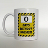 White ceramic coffee mug featuring a parody safety sign graphic that reads: 