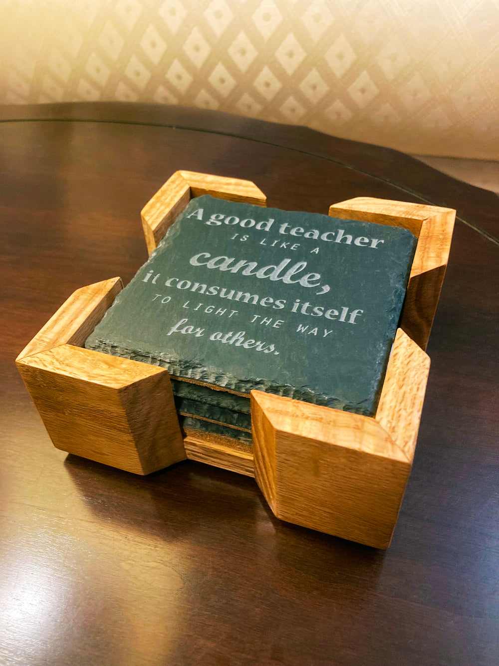 This handmade coaster holder is made from solid oak wood. Add this beautiful holder to keep your coasters neat and tidy. Felt feet to protect from scratching. Add this upgrade to your gift purchase. Holder only. Coasters sold separately. Outside Dimensions: 5-1/8"L x x5-1/8"W x 1-3/4"HInside Dimensions: 4-1/8"L x 4-1/8"W x 1-1/4"H