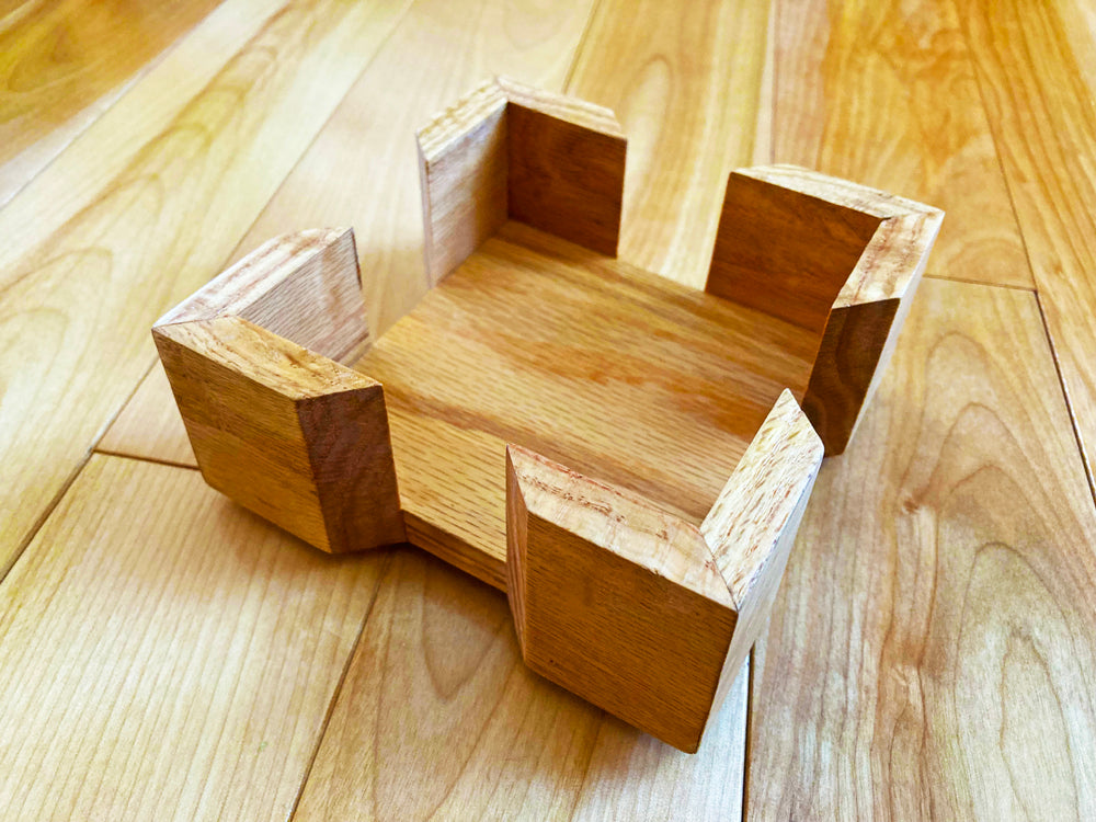 This handmade coaster holder is made from solid oak wood. Add this beautiful holder to keep your coasters neat and tidy. Felt feet to protect from scratching. Add this upgrade to your gift purchase. Holder only. Coasters sold separately. Outside Dimensions: 5-1/8"L x x5-1/8"W x 1-3/4"HInside Dimensions: 4-1/8"L x 4-1/8"W x 1-1/4"H