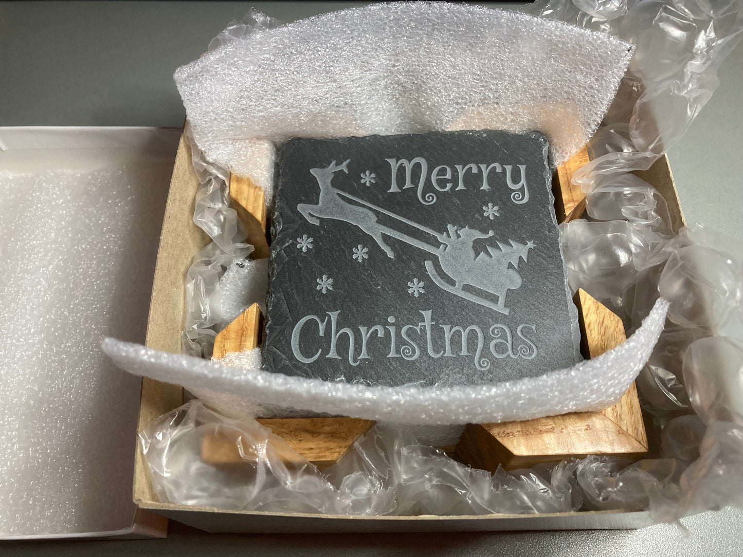 Merry Christmas Coaster. A great gift for the holidays. Get a set for entertaining guests. Carved to a depth and quality that cannot be achieved with simple engraving. Buy as a single, or mix and match in sets of 2 or 4. Add a Coaster Holder and/or Gift Box. Each sold separately.