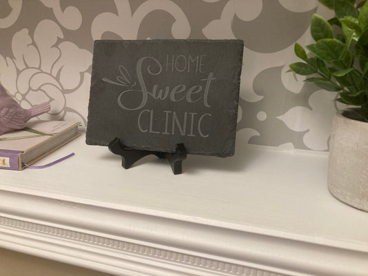 Home Sweet Clinic sign with dragonfly with stand, on a shelf. 5"W x 7"H Sand-carved slate sign.