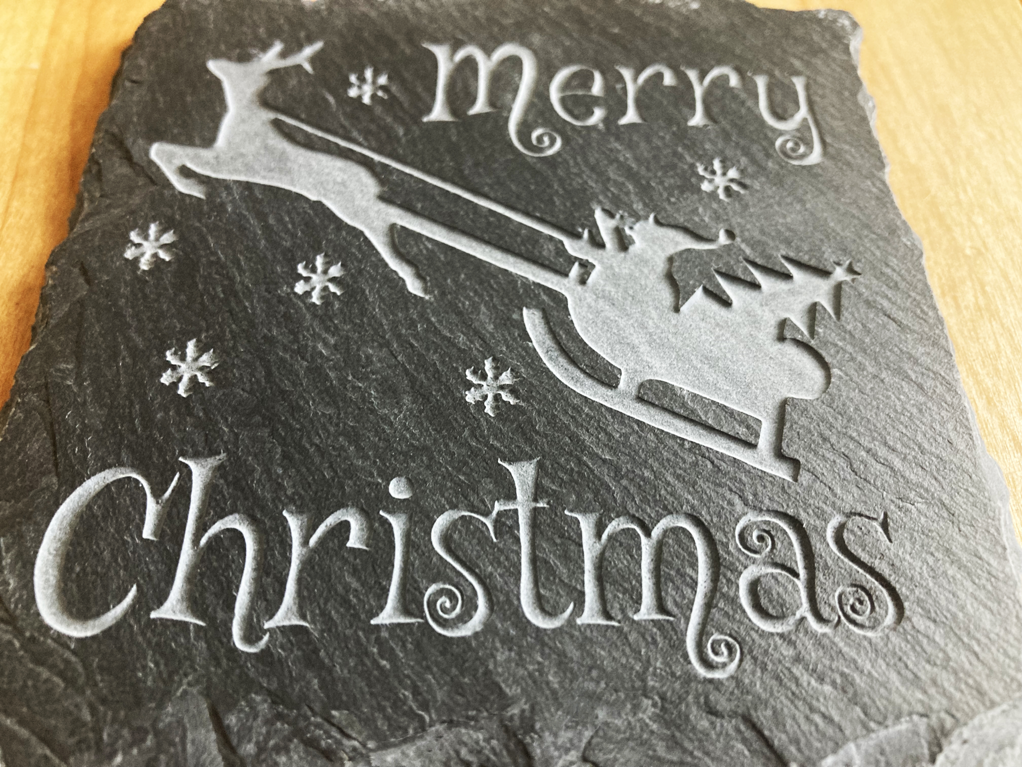 Merry Christmas Coaster. A great gift for the holidays. Get a set for entertaining guests.  Carved to a depth and quality that cannot be achieved with simple engraving.  Buy as a single, or mix and match in sets of 2 or 4.  Add a Coaster Holder and/or Gift Box. Each sold separately.