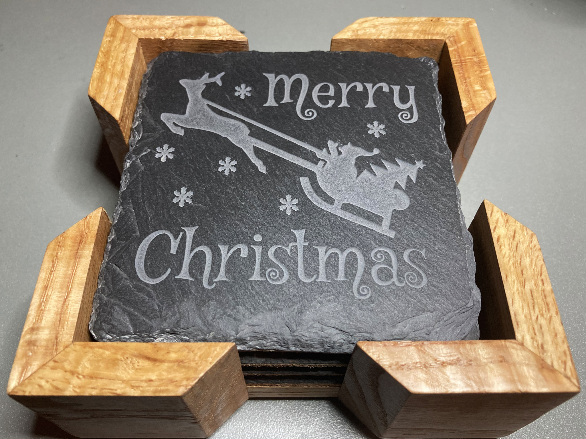 Merry Christmas Coaster. A great gift for the holidays. Get a set for entertaining guests.  Carved to a depth and quality that cannot be achieved with simple engraving.  Buy as a single, or mix and match in sets of 2 or 4.  Add a Coaster Holder and/or Gift Box. Each sold separately.